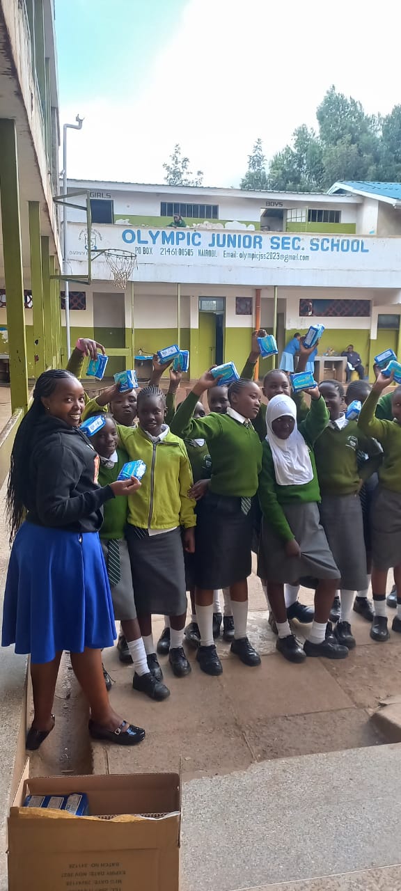 Students at Olympic Junior Secondary School celebrating with sanitary products from Period Pride Kenya